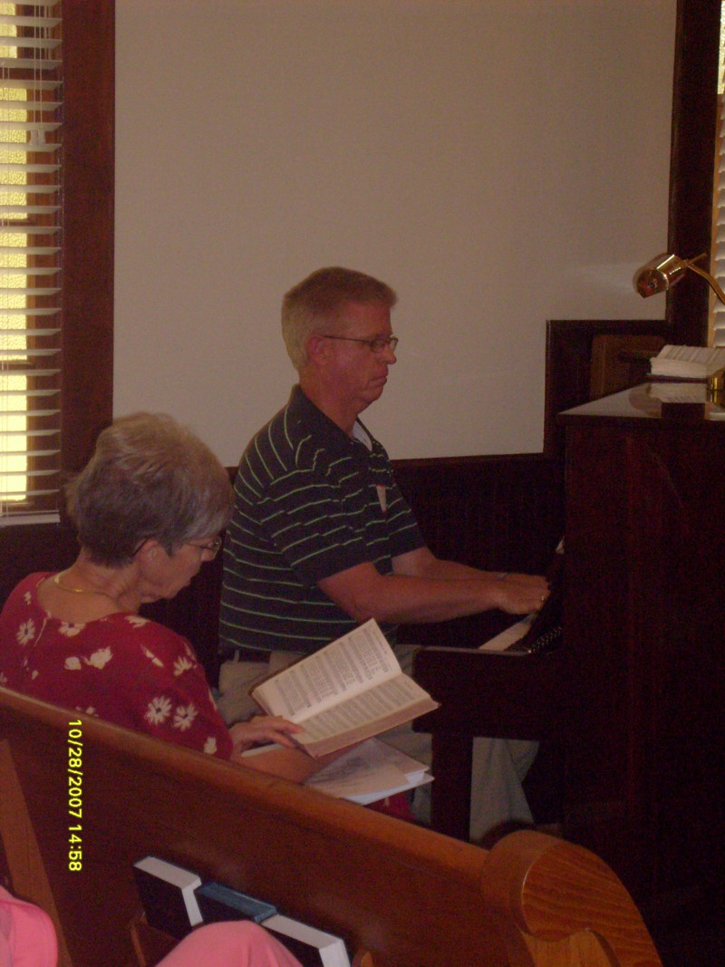 Ed playing the Piano that Harriet gave to the church in memory of her mother