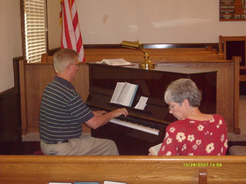 Ed playing the Piano that Harriet gave to the church in memory of her mother